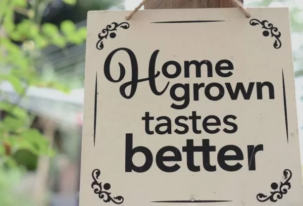 garden sign home grown tastes better, black font on light background.